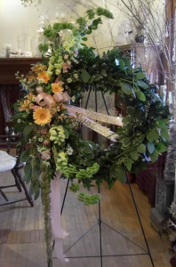 Floral Wreath with Bells of Ireland, Snapdragons, Large Gerbera, Alstroemeria and Monte Cassino with a variety of mixed greenery