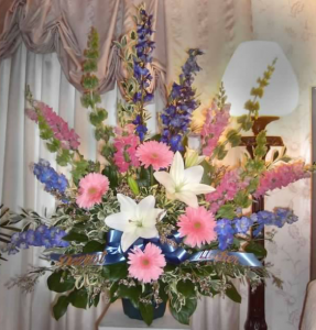 Traditional Tribute with Bells of Ireland, Delphinium, Snapdragons, Large Gerbera Daisy, Oriental Lilies, and Limonium