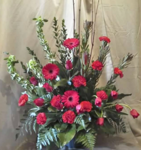 Traditional Tribute with Bells of Ireland, Safari Sunset, Roses, Large Gerbera Daisy, Carnations and Tulips