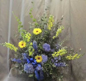 Traditional Tribute with Bells of Ireland, Delphinium, Snapdragons, Large Gerbera Dasiy and blue Hydrangeas
