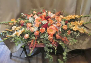 Casket Spray with Gladiolas*, Snapdragons, Large Gerbera Daisy, Roses, Cockscomb and Queen Annes Lace