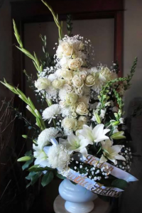 Cross Tribute with Snapdragons, Gladiolas, Football Mums, Asiatic Lilies, Large and Spray Roses, Hydrangeas, and Gypsophilia
