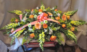 Casket Spray with Snapdragons, Large Gerbera Daisy, Roses, Alstroemeria, "Green Cushion"Pom Mums, and Solidaster
