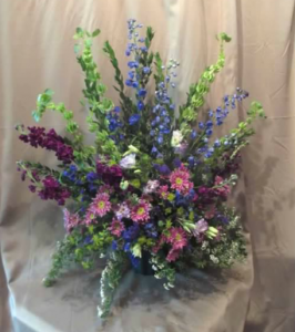 Traditional Tribute with Bells of Ireland, Delphinium, Stock, Lisianthus and Daisy Mums