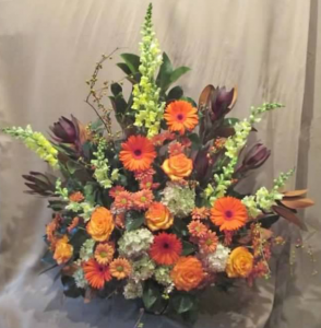 Traditional Tribute with Snapdragons, Safari Sunset, Large Gerbera Daisy, Roses, Pom Mums and Antique* Hydrangeas