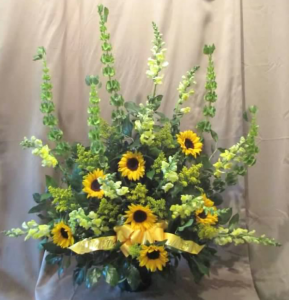Traditional Tribute with Snapdragons, Bells of Ireland, Sunflowers, and Solidaster