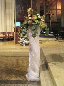 Organza wrapped column with Hydrangea, Roses, and Eucalyptus