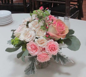 Glass vase centerpiece with Pink and Ivory Roses, Eucalyptus, and Dusty Miller