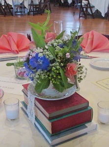 Book and Tea Cup Centerpiece with Pink Mini Rose, Blue Delphinium and Babies Breath 